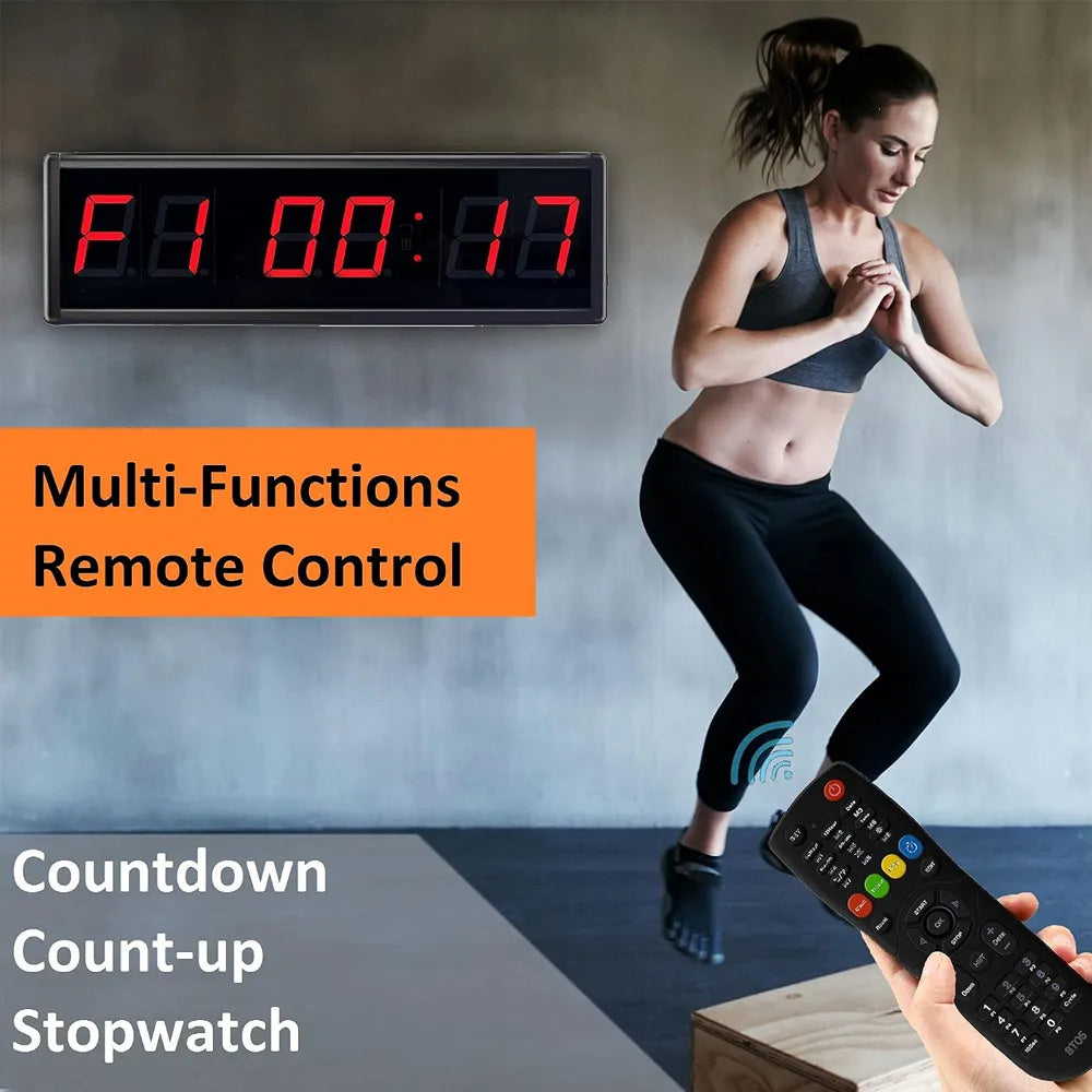 A digital wall-mounted stopwatch display with red LED digits, shown in a home gym setting next to a woman exercising. A hand holds a black remote control in the foreground, with text overlays reading 'Multi-Functions Remote Control', 'Countdown Count-up Stopwatch', and 'Countdown Count-up Stopwatch'.