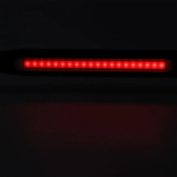 A horizontal red LED light bar, likely a vehicle tail light or brake light, shown illuminated against a dark background.