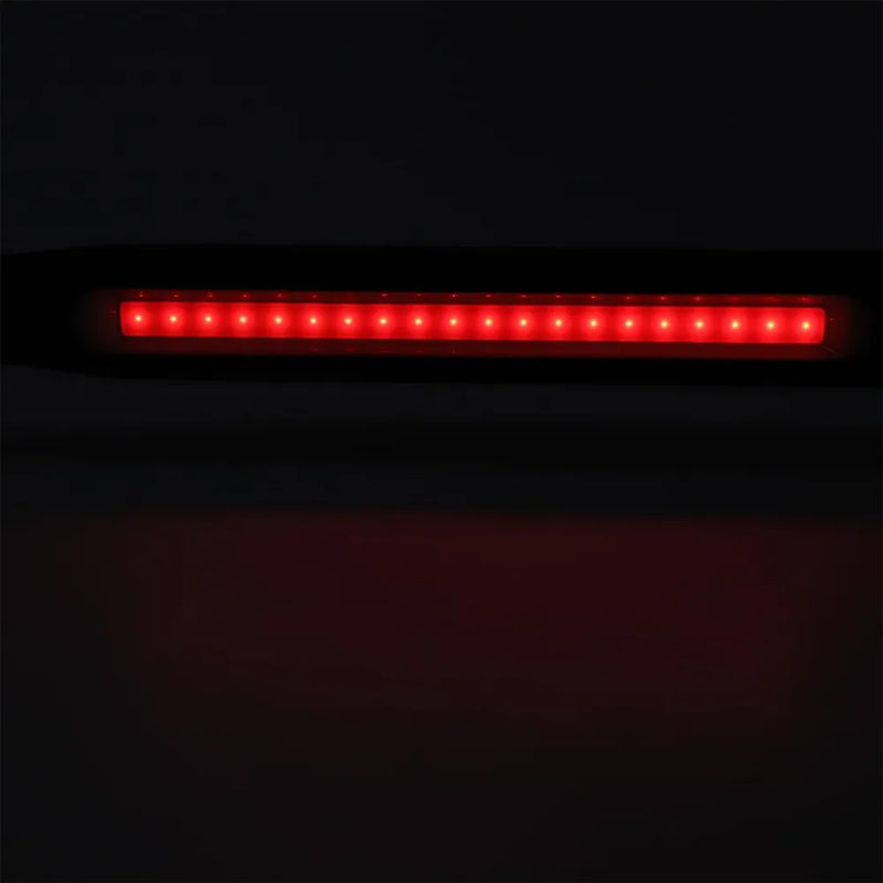 A horizontal red LED light bar, likely a vehicle tail light or brake light, shown illuminated against a dark background.
