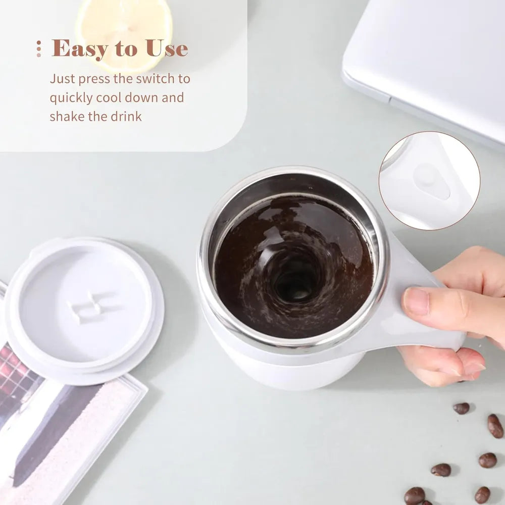 White cup with dark liquid, surrounded by coffee beans on a light gray surface.