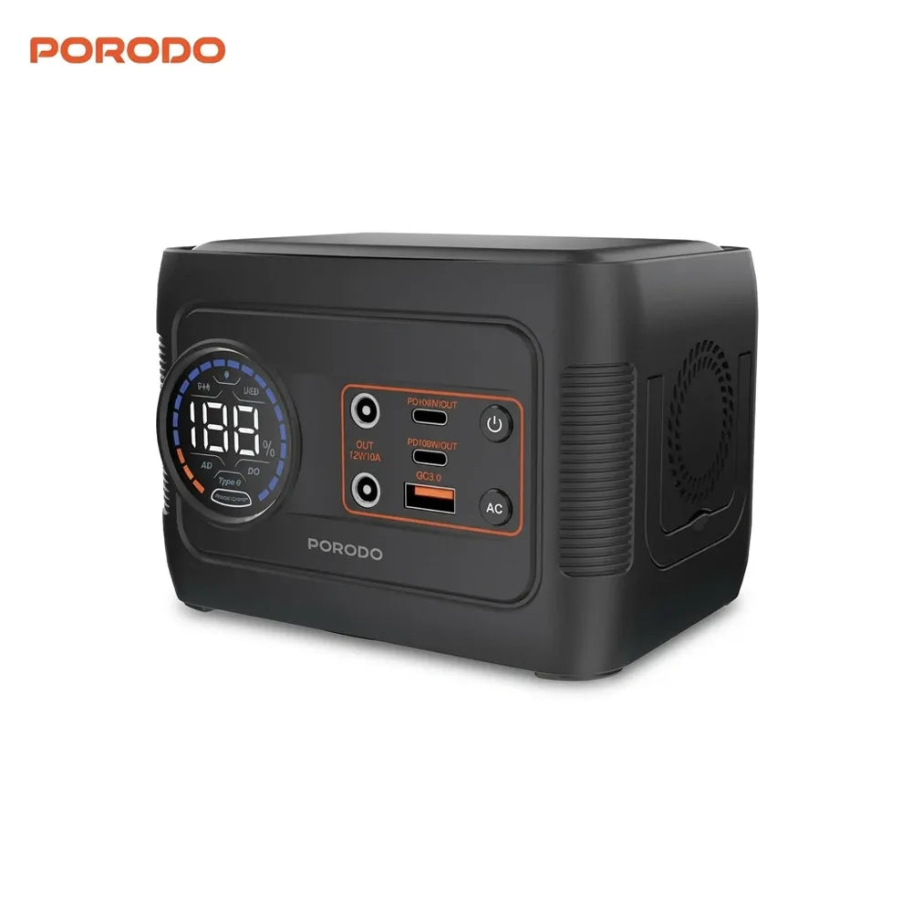 A black portable power station by PORODO with a digital display screen, multiple USB-A and USB-C ports, and orange accent details, shown on a plain white background.