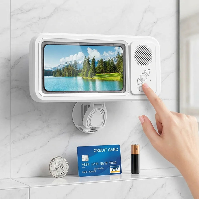 A white wall-mounted electronic device with a screen showing a lake landscape and control buttons on the right, mounted on a marble bathroom wall. A hand is touching the buttons, and a credit card and coin are placed below for scale.