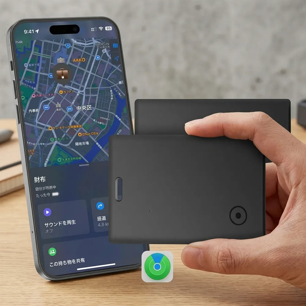 A hand holds a black rectangular smart card or tracker device in front of a smartphone showing a map app, set on a wooden surface with a blurred indoor background.